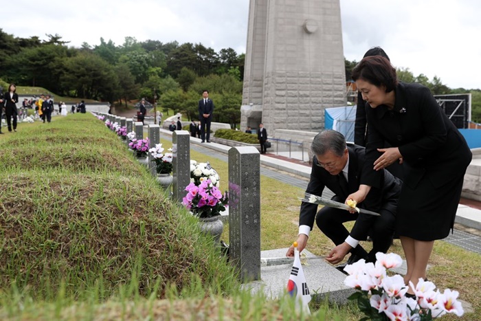 5月18日，出席5.18光州民主化运动第39周年纪念仪式的韩国总统文在寅夫妇正在牺牲者墓地鲜花。图片来源：青瓦台