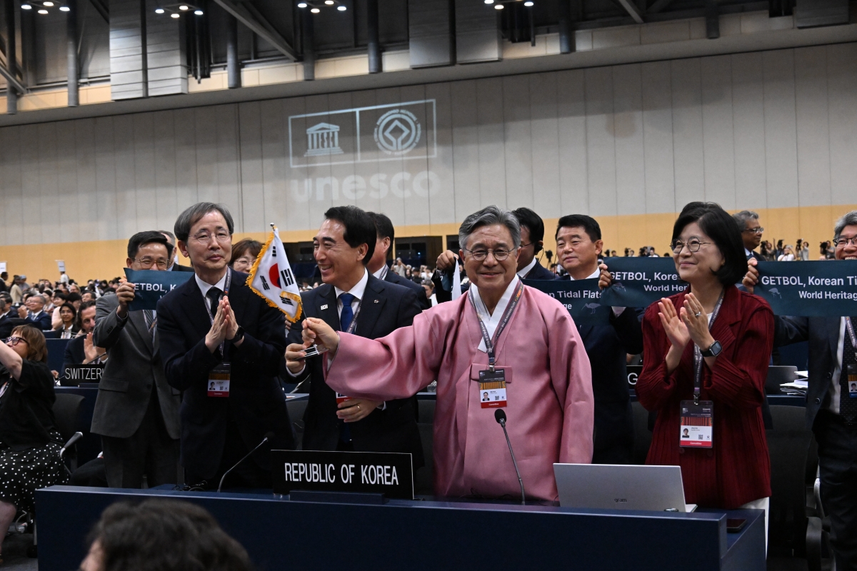 7月25日，在釜山海云台区BEXCO，韩国国家遗产厅厅长许民（右二）、韩国常驻联合国教科文组织代表部大使金智熙（右一）等韩国政府代表团成员获悉“韩国滩涂”第二阶段扩展列入世界遗产成功后，共同庆祝。图片来源：国家遗产厅