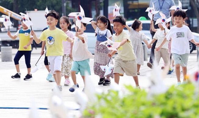 孩子们手握太极旗图案风车奔跑