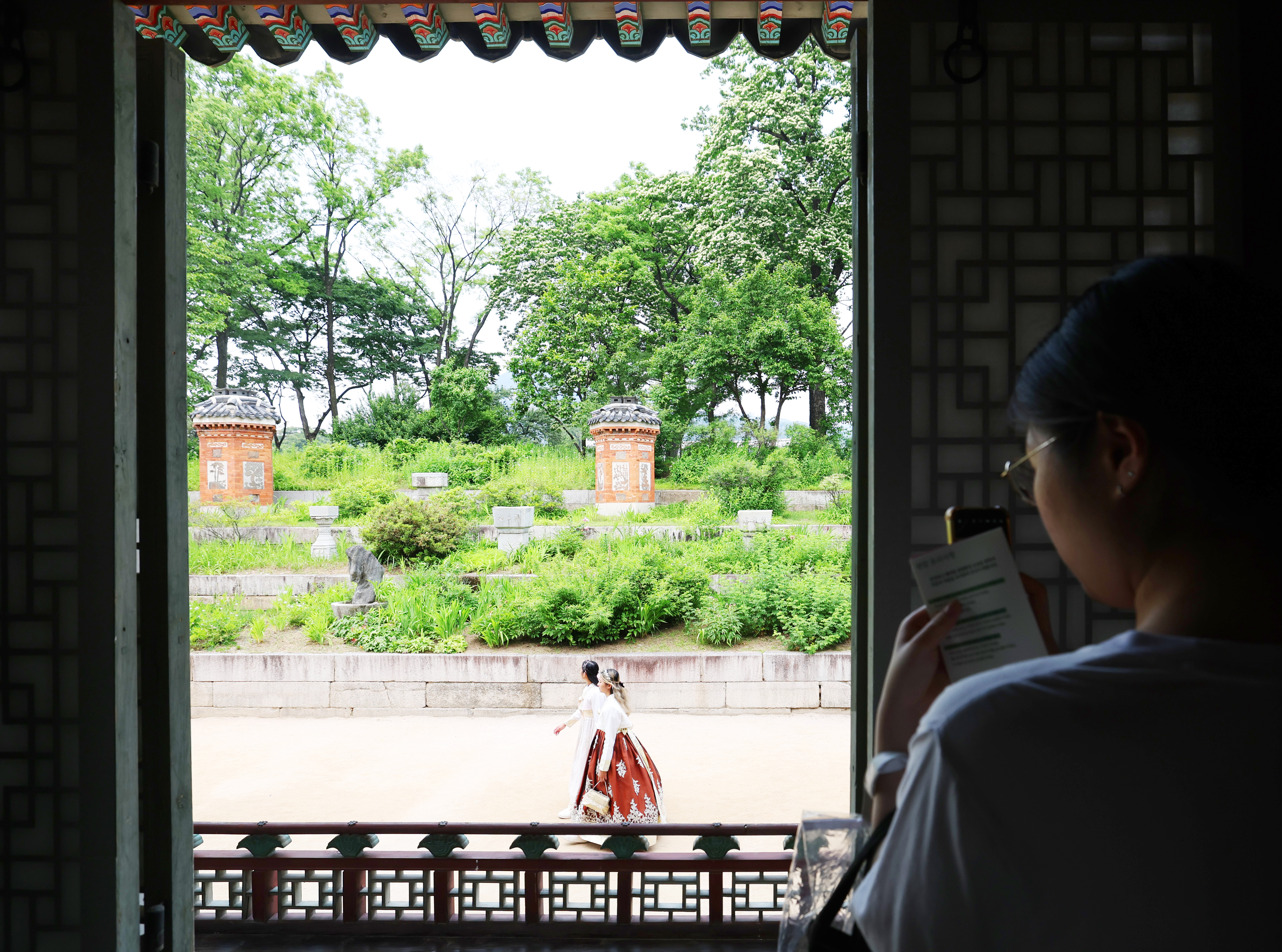 5月28日，在首尔景福宫交泰殿举行的特别开放活动“王妃的视线”中，一位游客正以为王妃准备的庭院——峨眉山为景拍照。